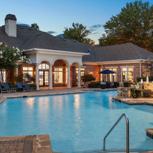 Resort-style swimming pool pool with lounge chairs