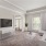 Living room with patio, oversized windows, seating, accent rug, and kitchen bar with stools