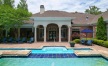 a large house with a pool and a large front yard